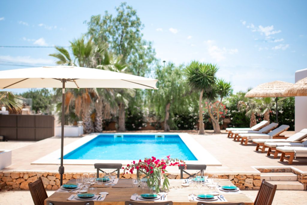Villa op Ibiza met zwembad en zicht op de groene heuvels.